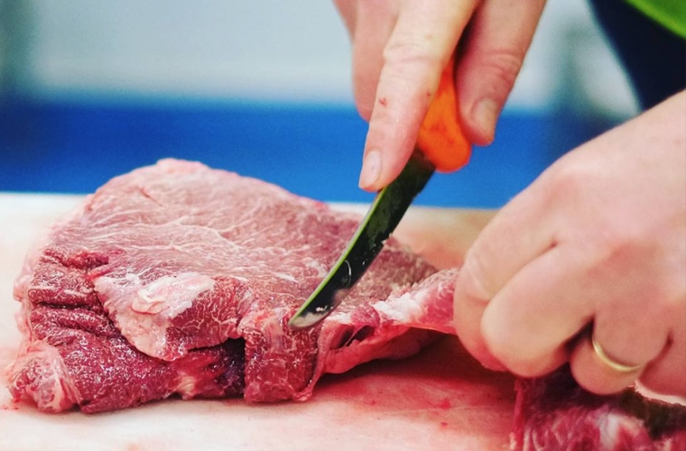 Carefully slicing meat - Red Candy